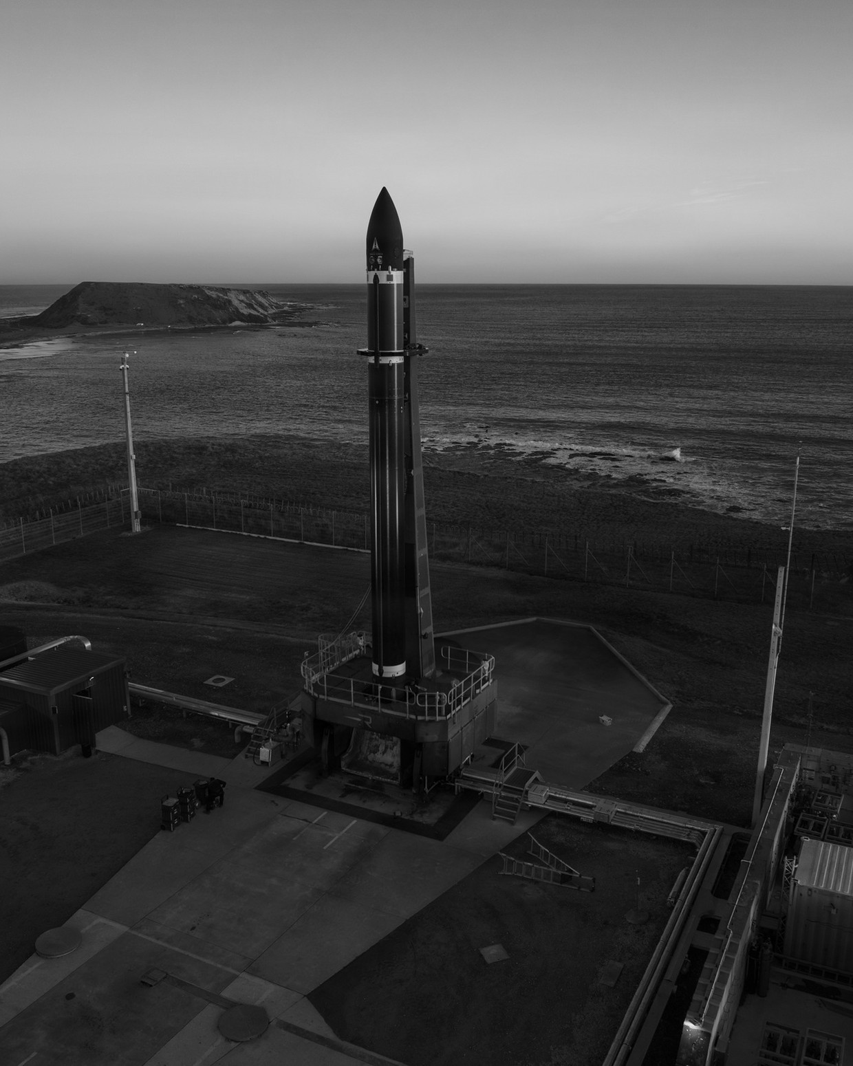 An Electron launch vehicle vertical on the pad at Rocket Lab Launch Complex 1 ahead of the VICTUS HAZE mission.